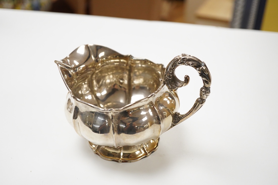A George IV silver cream jug, with engraved monogram, by William, Charles and Henry Eley, London, 1824, height 10.5cm, 7.7oz.